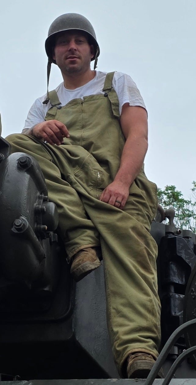 Andrew Strain sitting on top of tank