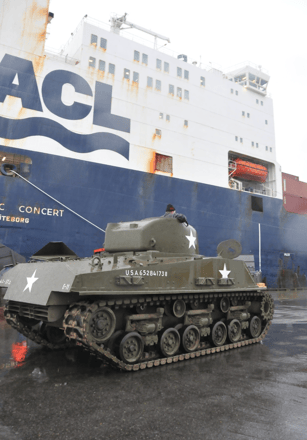 Sherman tank in front of cargo boat