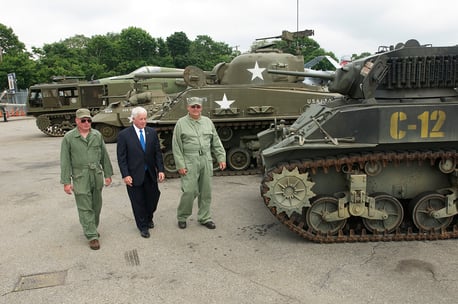 Charles Lavine and Museum workers in front of tanks