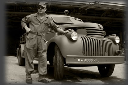 Mark Renton in front of military vehicle