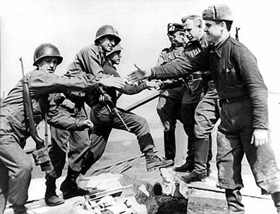 Russian federation soldiers shaking hands atop Mountain