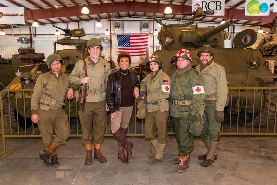 Stop & Shop’s Arlene Putterman is surrounded by WW II living historians at the Museum of American Armor