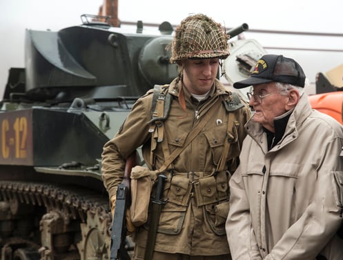 WWII enactor helping WWII elderly veteran