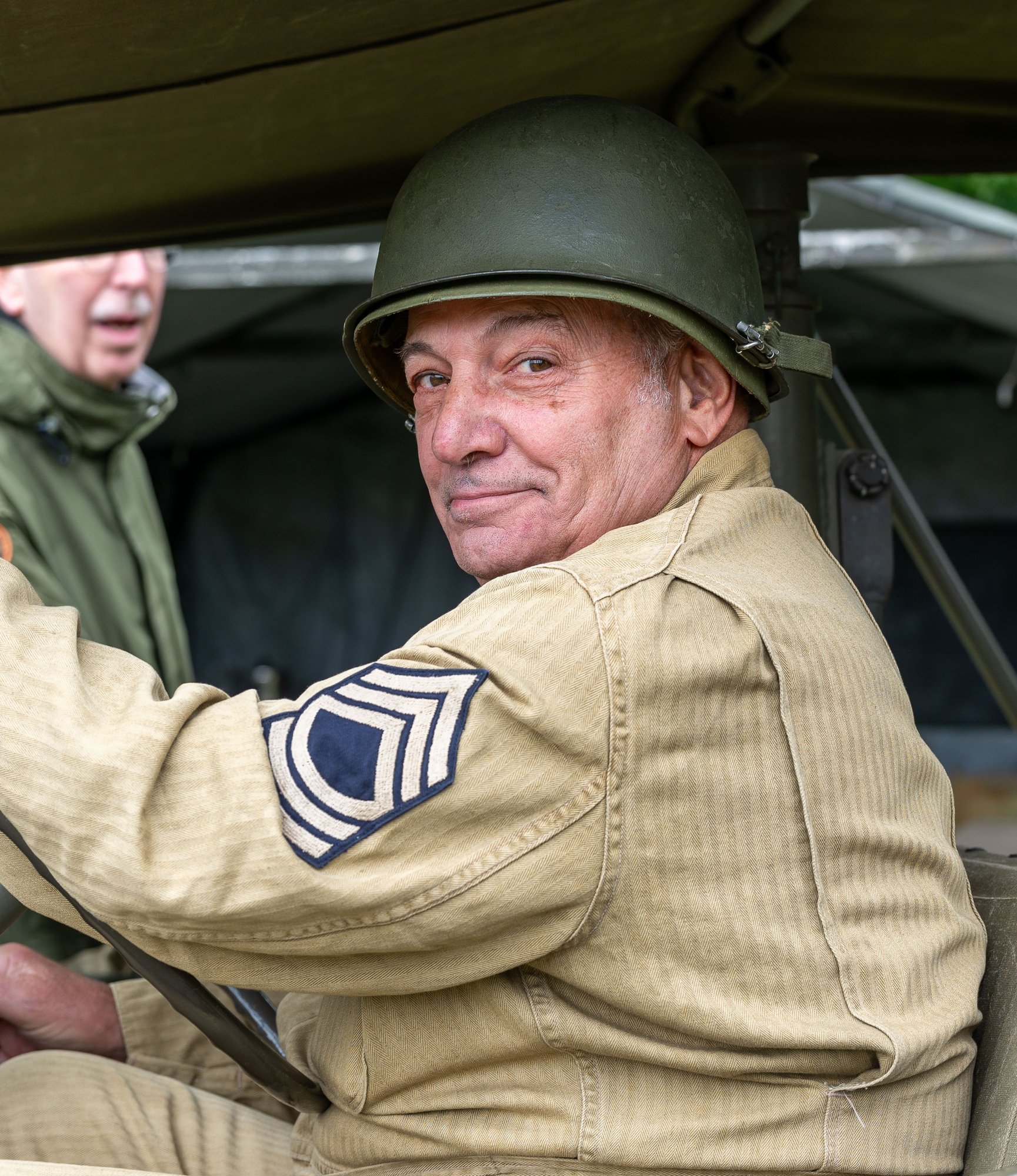 Louis Forrisi in uniform driving car