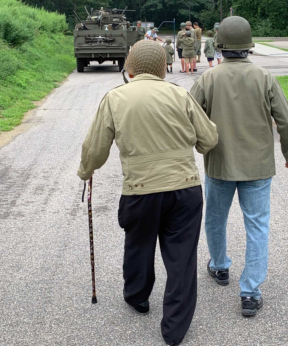 Long Island veterans walking towards military vehicle with families around
